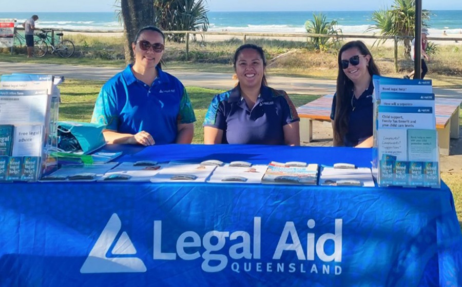 Three legal aid staff at a community event